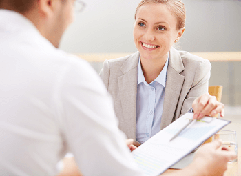 an insurance agent going over a life insurance policy with a client