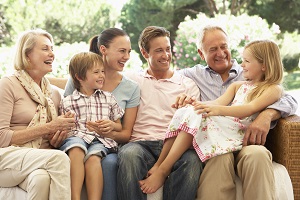 family gathered around each other laughing